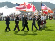 ESTES PARK, Colo. – From left to right: Coast Guard Petty Officer 1st Class TJ Thomas, Marine Staff Sgt. Daniel Gibbons, Canadian Forces Sgt. Craig Adamson, Canadian Forces Petty Officer 2nd Class Jason McNeil, Canadian Forces Cpl. Danette Weyh, and Gunnery Sgt. Steven Poinsette, members of the North American Aerospace Defense Command and U.S. Northern Command Color Guard, march at the opening ceremonies of Tattoo Estes 2011, a highland festival that took place in Estes Park, Colo., Sept. 8 – 11. A traditional joint service Color Guard will normally carry the U.S. flag and all service flags in order of seniority with a guard on both ends. At NORAD and USNORTHCOM, the Color Guard carries a variety of combinations but always carry the U.S. and Canadian flags. 

(Canadian Forces photo by LCdr. Desmond James) 

