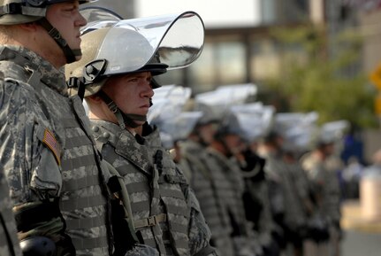 Minnesota National Guard Soldiers with the 1st Combined Arms Battalion, 194th Armor stand guard to assist police in maintaining order during an overly-aggressive demonstration Sept. 1, in St. Paul, Minn. The demonstrators were protesting during day one of the Republican National Convention.