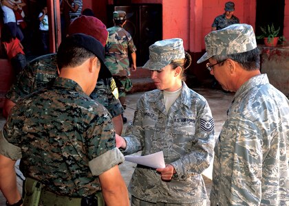 Tech. Sgt. Shirley Morales, 163d Reconnaissance Wing force development technician, reviews a script with U.S. and Guatemelan military members prior to an opening ceremony welcoming the 163d Medical Group to the country to provide medical care to the local citizens.