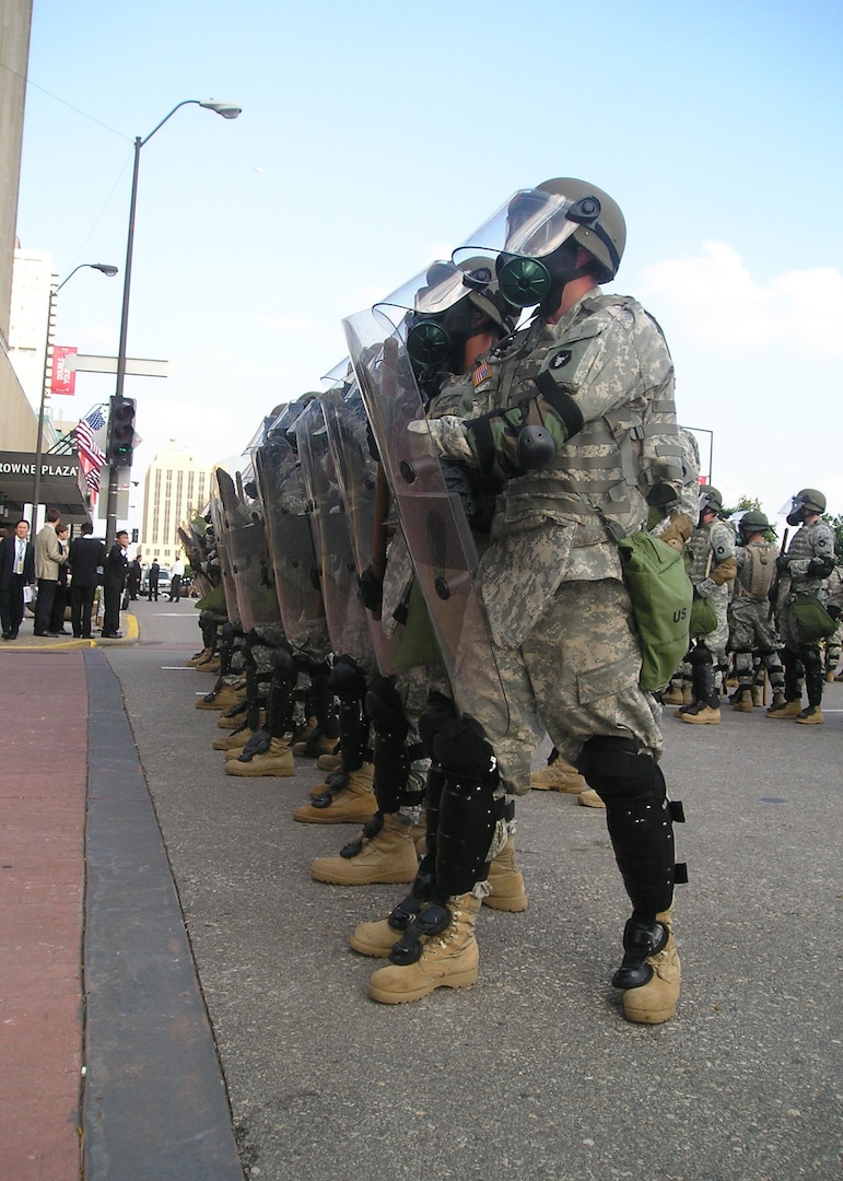 Minnesota National Guard Soldiers with the 1st Combined Arms Battalion, 194th Armor stand guard to assist St. Paul Police in maintaining order during an overly-aggressive demonstration Sept. 1, 2008 in St. Paul, Minn. The demonstrators were protesting during day one of the Republican National Convention.