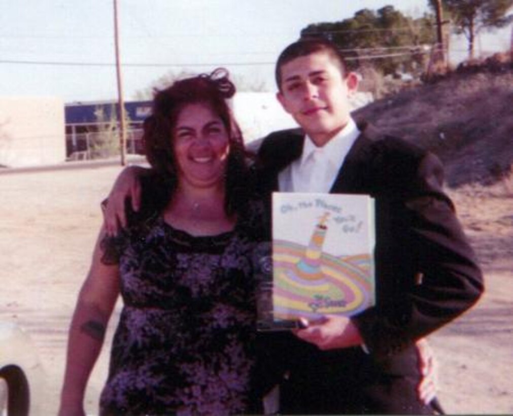 Aurelia Garcia, aka Mona, a food service worker at the Family Restaurant on Marine Corps Logistics Base Barstow, Calif., poses with her son, Esiquio Hernandez, after completing a class. Garcia supports her children through their struggles and guides them down the right path.


