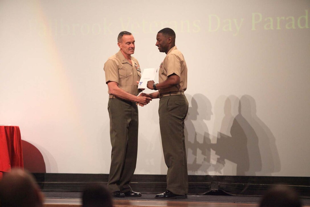 Lt. Col. Ahmed Williamson, the commanding officer of 9th Communication Battalion, I Marine Expeditionary Force, receives the Small Unit Volunteer of the Year award on behalf of his battalion at the Volunteer Recognition Ceremony at Camp Pendleton, Calif., April 25. The 9th Comm. Bn., Marines accumulated more than 3,200 hours of service while volunteering with Fallbrook Veterans of Foreign Wars, Magdalena Ecke Family YMCA, and various community outreach programs.