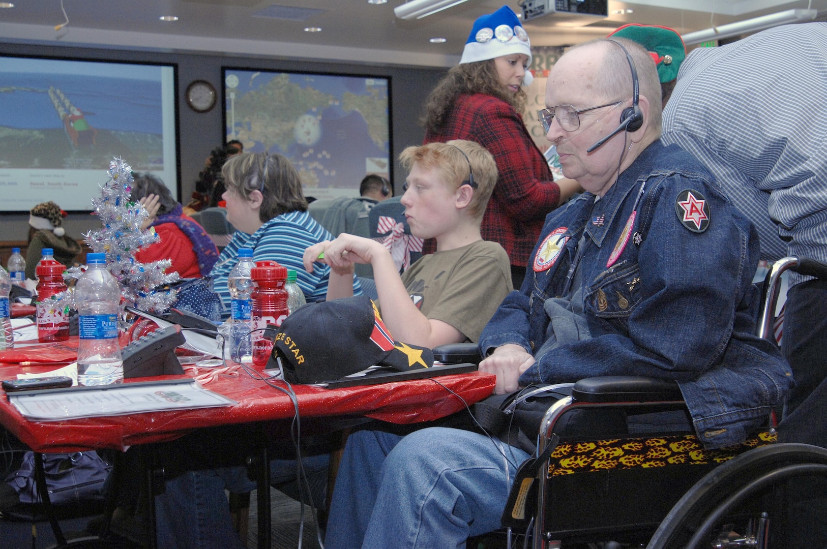 PETERSON AIR FORCE BASE, Colo. - James H. Mulhern, U.S. Army retired, takes calls at the NORAD Tracks Santa Operations Center on Peterson Air Force Base Christmas Eve. Mulhern was a tank commander in Vietnam with the 1st Infantry Division and served in the U.S. Army from 1963 to 1983. (U.S. Air Force photo by Tech. Sgt. Thomas J. Doscher)
