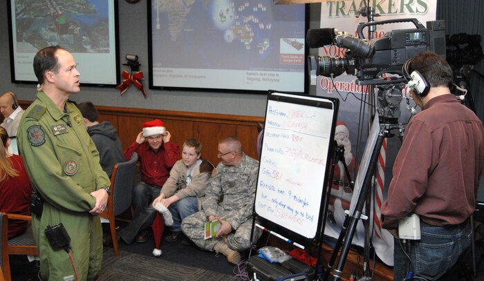 PETERSON AIR FORCE BASE - Lt.-Gen. Tom Lawson, North American Aerospace Defense Command deputy commander, gives a media interview via satellite from the NORAD Tracks Santa Operations Center Dec. 24, 2011. NORAD and U.S. Northern Command leaders conducted more than 20 media interviews from the Operations Center on Christmas Eve. (U.S. Air Force photo by Tech. Sgt. Thomas J. Doscher)