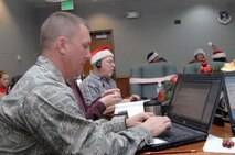 PETERSON AIR FORCE BASE, Colo. - Air Force Lt. Col. Rich Fletcher answers E-mails from childern asking for the current location of Santa Claus in the NORAD Tracks Santa Operations Center Dec. 24, 2011. Volunteers answered 7,721 E-mails on Christmas Eve and into Christmas morning, an increase of nearly 700 E-mails from last year’s count. (U.S. Air Force photo by Tech. Sgt. Thomas J. Doscher)

