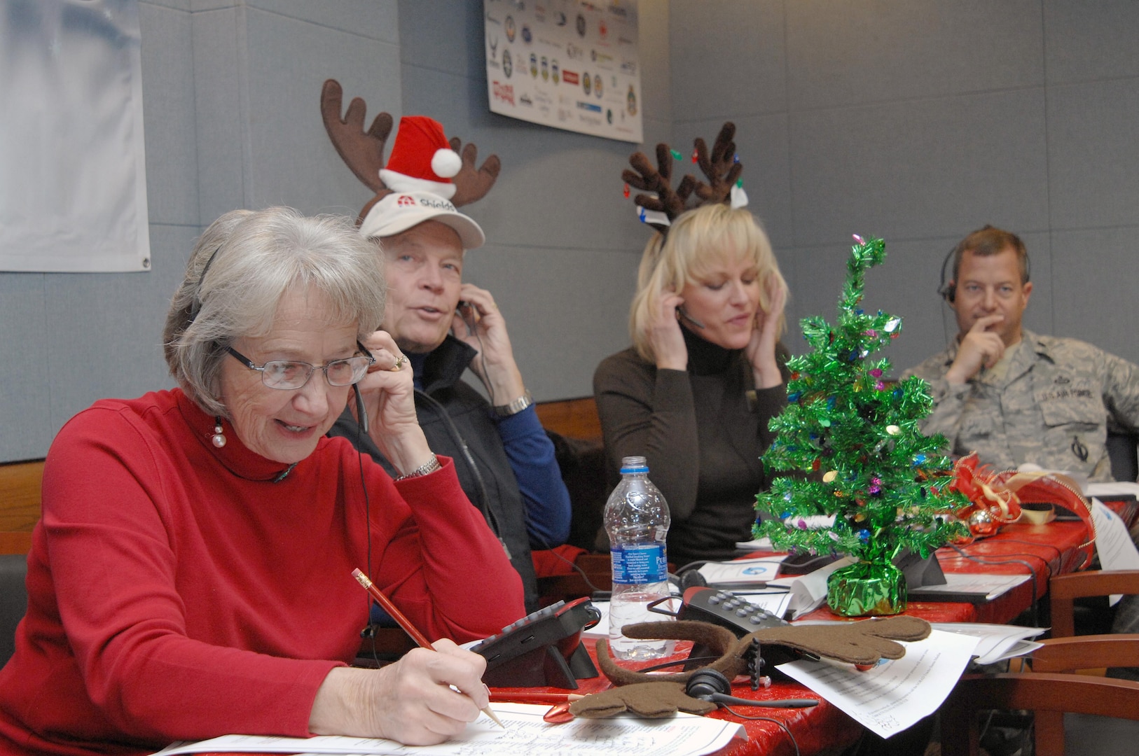PETERSON AIR FORCE BASE, Colo. - Volunteers take calls from children at the NORAD Tracks Santa Operations Center Dec. 24, 2011. More than 1,200 volunteers in the 23-hour NORAD Tracks Santa operations center answered nearly 102,000 calls this year from children looking for Santa Claus (up over 20,000 from 2010). Volunteers ranged from Peterson AFB family members volunteering their time to First Lady Michelle Obama, who for the second year, answered NORAD Tracks Santa calls from Hawaii. (U.S. Air Force photo by Tech. Sgt. Thomas J. Doscher)