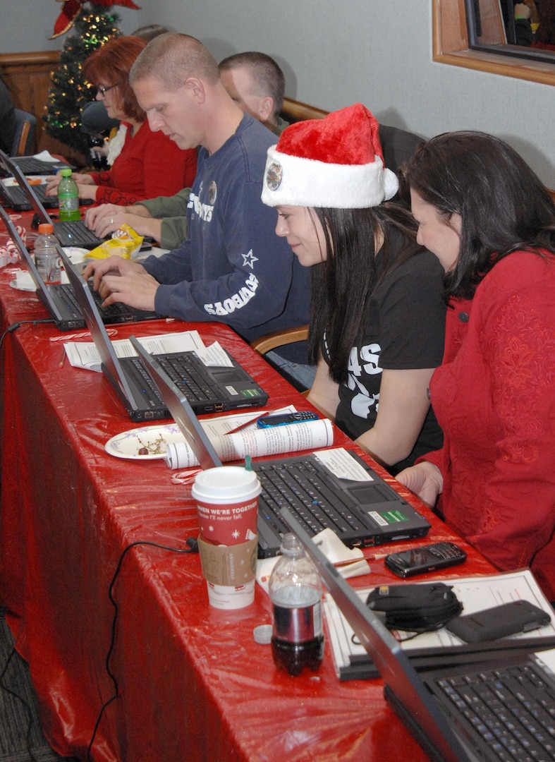 PETERSON AIR FORCE BASE, Colo. - Volunteers take calls from children at the NORAD Tracks Santa Operations Center Dec. 24, 2011. More than 1,200 volunteers in the 23-hour NORAD Tracks Santa operations center answered nearly 102,000 calls this year from children looking for Santa Claus (up over 20,000 from 2010). Volunteers ranged from Peterson AFB family members volunteering their time to First Lady Michelle Obama, who for the second year, answered NORAD Tracks Santa calls from Hawaii. (U.S. Air Force photo by Tech. Sgt. Thomas J. Doscher)