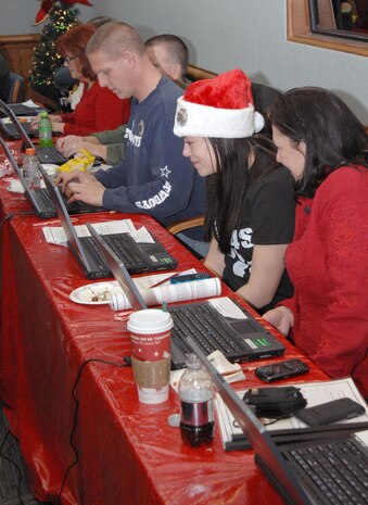 PETERSON AIR FORCE BASE, Colo. - Volunteers take calls from children at the NORAD Tracks Santa Operations Center Dec. 24, 2011. More than 1,200 volunteers in the 23-hour NORAD Tracks Santa operations center answered nearly 102,000 calls this year from children looking for Santa Claus (up over 20,000 from 2010). Volunteers ranged from Peterson AFB family members volunteering their time to First Lady Michelle Obama, who for the second year, answered NORAD Tracks Santa calls from Hawaii. (U.S. Air Force photo by Tech. Sgt. Thomas J. Doscher)