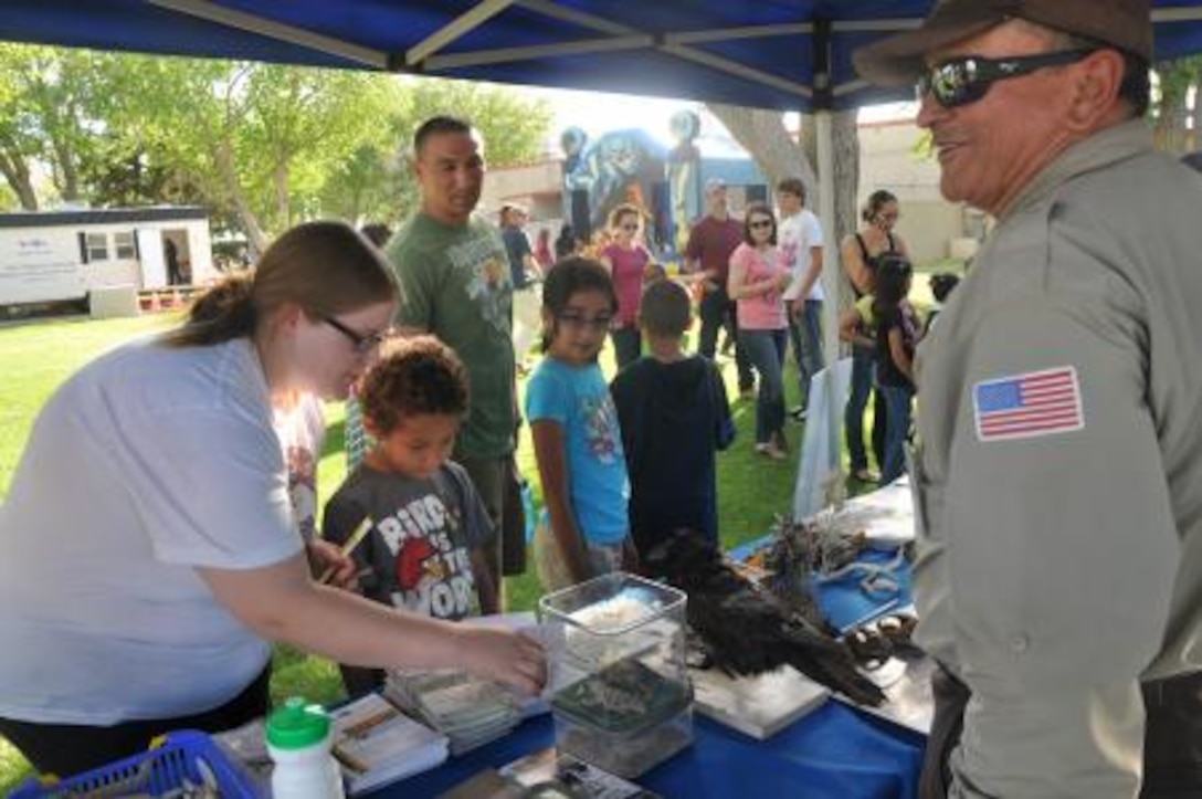 Art Basulto, an employee of the Bureau of Land Management, shows curious children animals indigenous to the High Desert at the base's Earth Day event held at McTureous Hall, April 11. Basulto travels to schools in the High Desert educating students about the dangers of pollution in the Mojave.


