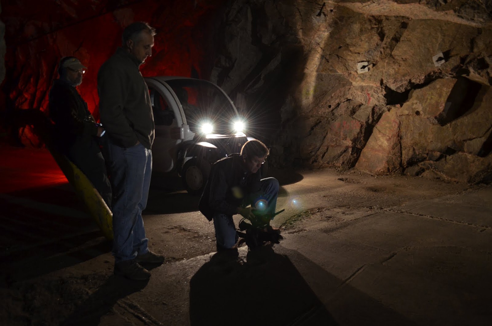 CHEYENNE MOUNTAIN AIR FORCE STATION, Colo. - Partisan Pictures’ cameraman Ben McCoy collects film footage in limited lighting within the tunnel leading to the south portal inside Cheyenne Mountain Air Force Station while producer Jonathan Grupper and sound specialist Thomas Wilson (left background) look on. Partisan Pictures captured film footage at Cheyenne Mountain Air Force Station for a documentary project during the second week of April 2012. The project also included rare footage of a multi-threat NORAD and USNORTHCOM exercise in the Alternate Command Center. 

(Canadian Forces photo by Lt. Alain Blondin) 

