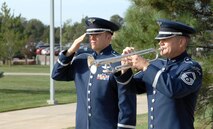 PETERSON AIR FORCE BASE, Colo. - (From left to right) Staff Sgt. Nicholas Daniels renders a salute while Senior Master Sgt. Steven Kindermann, U.S. Air Force Academy Band, plays Taps in honor of the NORAD and USNORTHCOM 9/11 Memorial Wreath-Laying Ceremony at the commands' headquarters Sept. 11, 2012.Every year, the NORAD and USNORTHCOM staff remember the victims of the 9/11 attacks with a ceremony commemorating their sacrifice. (U.S. Air Force photo by Michael Kucharek) 