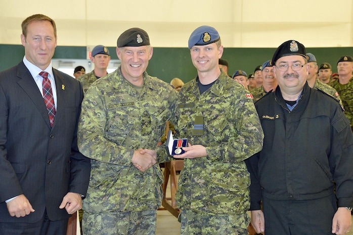 OTTAWA - Service Rifle Champion, Capt. Ken Barling, NORAD and member of Aerospace Telecommunication Engendering Sport Squadron, is awarded the Queen's Medal for Champion Shot by the Chief of the Defence Staff, General Walter Natynczyk, the Minister of National Defence, Peter MacKay, and the Canadian Forces Chief Warrant Officer, Chief Petty Officer 1st class Bob Cléroux, during the Canadian Forces Small Arms Concentration award ceremony held on September 22, 2012 at Connaught Ranges Ottawa, Ontario. 

(Canadian Forces photo by Cpl. Anthony Laviolette) 

