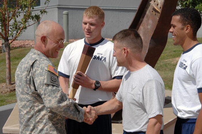 PETERSON AIR FORCE BASE, Colo. - Army Maj. Gen. Charles Luckey, NORAD and USNORTHCOM Chief of Staff, shakes hands with Air Force Brig. Gen. Gregory Lengyel, U.S. Air Force Academy Commandant, after presenting the Remembrance Run baton to U.S. Air Force Academy Cadet Wing Commander Daniel Zotto on Peterson Air Force Base, Colo., Sept. 13, 2012. The Remembrance Run, conducted in recognition of POW/MIA Recognition Day as well as the victims of 9/11, is a relay run spanning 45 miles through Colorado Springs and began at the NORAD and USNORTHCOM 9/11 Memorial. Each five-person team of cadets runs one mile, ending with a 39-hour run commemorating the 39 years since Operation Homecoming, which airlifted U.S. prisoners of war from North Vietnam. 

(U.S. Air Force photo by Tech. Sgt. Thomas J. Doscher) 

