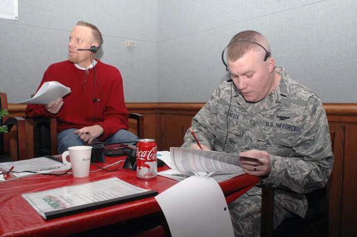PETERSON AIR FORCE BASE, Colo. - 1st Lt. Jeremy Hancock, 21st Operations Support Squadron, takes a call while volunteering at the NORAD Tracks Santa Operations Center Dec. 24. More than 1,200 volunteers took more than 114,000 phone calls during the 24 hour period that NORAD tracked Santa in 2012. (U.S. Air Force photo by Tech. Sgt. Thomas J. Doscher)