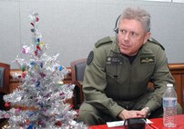 PETERSON AIR FORCE BASE, Colo. - Canadian Lt.-Gen. Alain Parent, NORAD Deputy Commander, takes some calls at the NORAD Tracks Santa Operations Center Dec. 24, 2012. After this photo was posted on Facebook, a parent commented that their son had just spoken to someone named "Parent' and that now her six-year-old was "freaking out." (U.S. Air Force photo by Tech. Sgt. Thomas J. Doscher)
