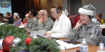 PETERSON AIR FORCE BASE, Colo. - Volunteers for NORAD Tracks Santa take calls at the NTS Operations Center Dec. 24, 2012. More than 1,200 volunteers took over 114,000 calls over a 24-hour period. (U.S. Air Force photo by Tech. Sgt. Thomas J. Doscher)
