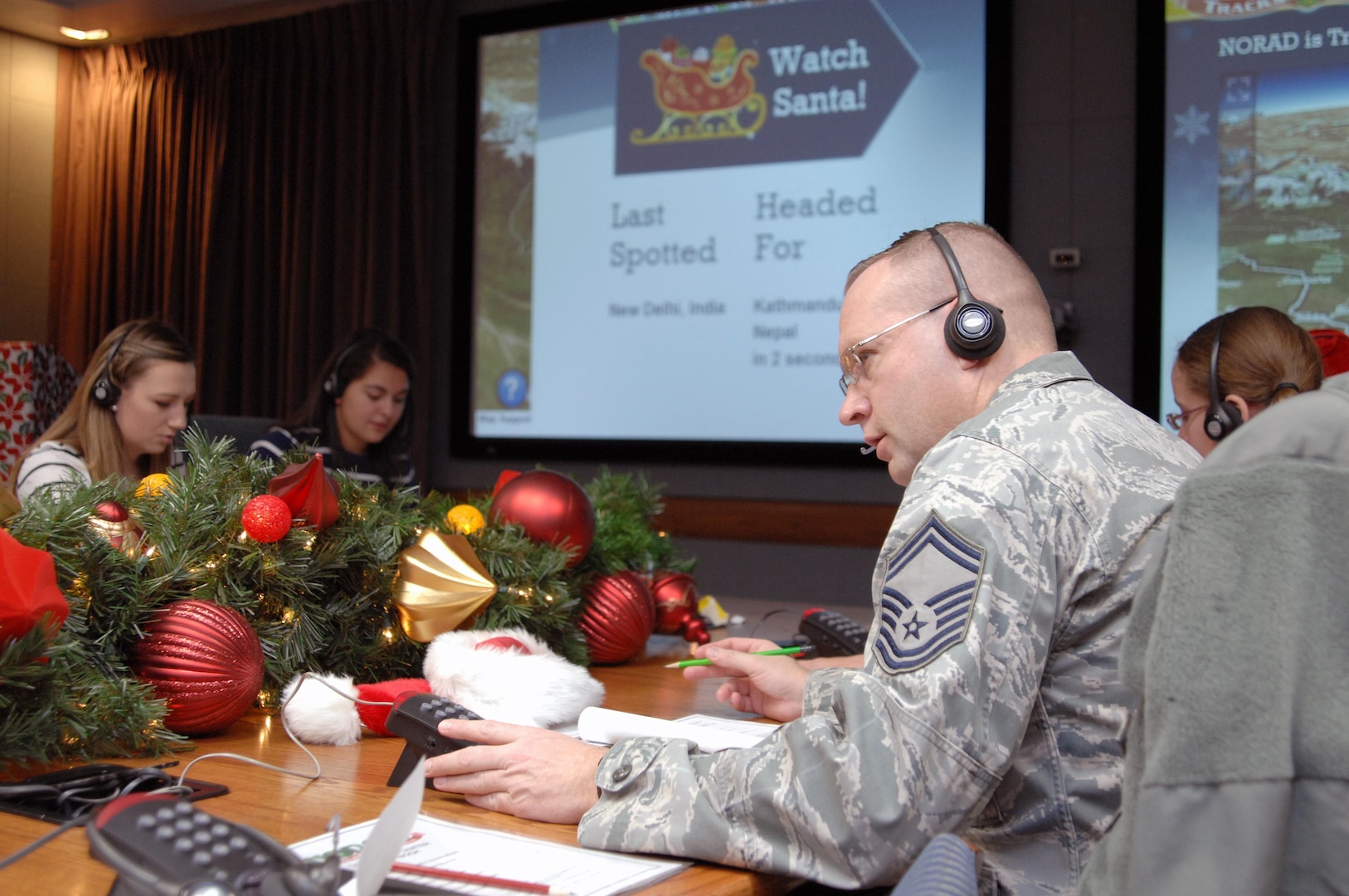 PETERSON AIR FORCE BASE, Colo. - Senior Master Sgt. Christopher Kozel, NORAD and USNORTHCOM J34, takes calls at the NORAD Tracks Santa Operations Center Dec. 24, 2012. Volunteers from every U.S. and Canadian military branch came out to volunteer during the 24 hours NORAD tracked Santa. (U.S. Air Force photo by Tech. Sgt. Thomas J. Doscher)