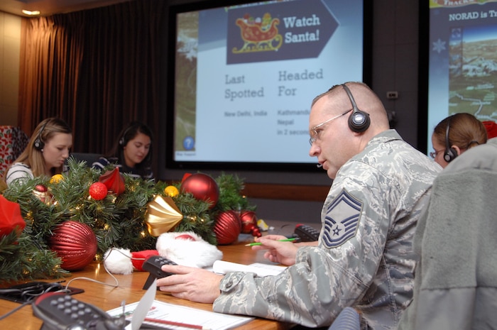 PETERSON AIR FORCE BASE, Colo. - Senior Master Sgt. Christopher Kozel, NORAD and USNORTHCOM J34, takes calls at the NORAD Tracks Santa Operations Center Dec. 24, 2012. Volunteers from every U.S. and Canadian military branch came out to volunteer during the 24 hours NORAD tracked Santa. (U.S. Air Force photo by Tech. Sgt. Thomas J. Doscher)