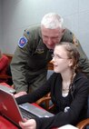PETERSON AIR FORCE BASE, Colo. - Lt. Col. Tom Courtney, NORAD J33, helps his daughter, Kristen, answer an email from a Santa tracker at the NORAD Tracks Santa Operations Center Dec. 24, 2012. Volunteers answered more than 7,000 emails from Santa trackers across the globe. (U.S. Air Force photo by Tech. Sgt. Thomas J. Doscher)