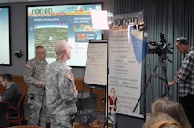 PETERSON AIR FORCE BASE, Colo. - Army Maj. Gen. Charles Luckey, NORAD and USNORTHCOM Chief of Staff, prepares to do a media interview via satellite from the NORAD Tracks Santa Operations Center Dec. 24, 2012. Dozens of interviews were conducted with NORAD leadership to get the word out on how NORAD tracks Santa every year. (U.S. Navy photo by LCDR. Bill Lewis)