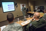 Brig. Gen. Glenn Curtis, standing, commander of Joint Task Force Pelican, briefs Gen. Gene Renuart, commander of U.S. Northern Command, on the status of National Guard assets supporting Hurricane Gustav recovery efforts Sept. 3. JTF Pelican headquarters are located in Carsville, La.