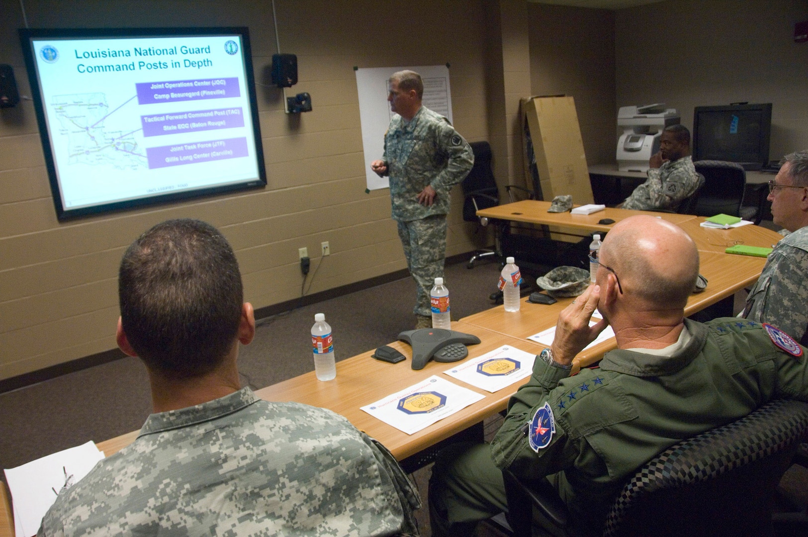Brig. Gen. Glenn Curtis, standing, commander of Joint Task Force Pelican, briefs Gen. Gene Renuart, commander of U.S. Northern Command, on the status of National Guard assets supporting Hurricane Gustav recovery efforts Sept. 3. JTF Pelican headquarters are located in Carsville, La.