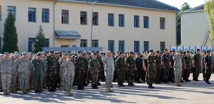 Servicemembers from the U.S., Ukraine, and 16 other countries present arms for the playing of the American and Ukrainian anthems during the Rapid Trident opening Ceremony.