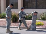 Military Policeman Spc. Dan Thomiassian, left, of the Nevada Army Guard's 137th Law and Order Detachment views proper arrest technique as Senior Airman Rebecca Gutierrez, center, detains Airman 1st Class Daniel Pauls on Aug. 16 at Nellis Air Force Base. About 20 Soldiers from the 137th worked in conjunction with Nellis security forces during the unit's two-week annual training period in August.