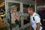 A Louisiana Army National Guard Soldier greets a New Orleans resident at the Union Passenger Terminal as he returns from Memphis, Tn. by train after being evacuation from the city prior to the arrival of Hurricane Gustav, September 5, 2008.