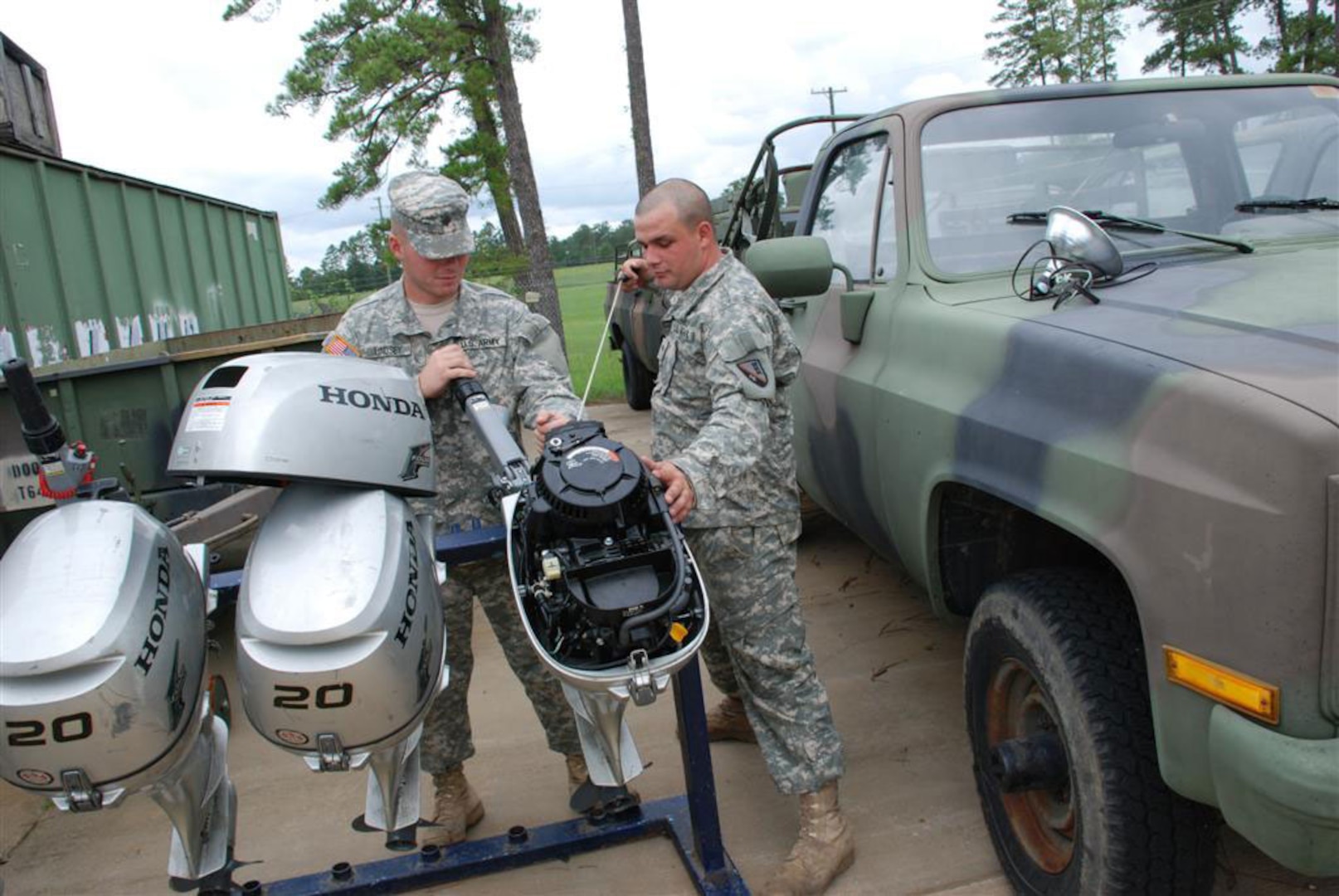 CAMP BEAUREGARD, La. - Spc. Joseph E. Lindsey and Spc. Brandon W. Beasley, both of West Monroe, La., test boat motors at Camp Beauregard in Pineville, La. The motors are used in 15-foot aluminum boats for Search and Rescue missions in the wake of natural disasters such as Hurricane Gustav. Lindsey and Beasley, who are assigned to Detachment 2, 844th Engineer Company, 527th Engineer Battalion in Ruston, La., are both mechanics in the Louisiana Army National Guard.