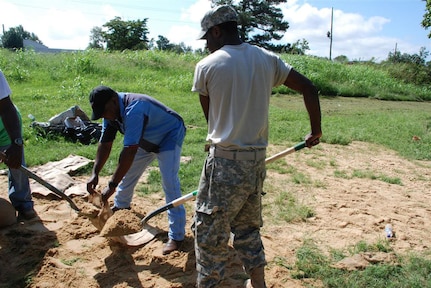 Louisiana Army National Guardsman Spc. Curtis L. Morrison of Lake Providence, La., and Mayor Floyd Baker of Bonita, La., fill sandbags to attempt to reduce the flooding threat in the small community of Bonita. Hurricane Gustav dumped over 17 inches of rain in Northeast Louisiana after making landfall on the coast of South Louisiana. Morrison is assigned to the 528th Engineer Battalion in Monroe, La.