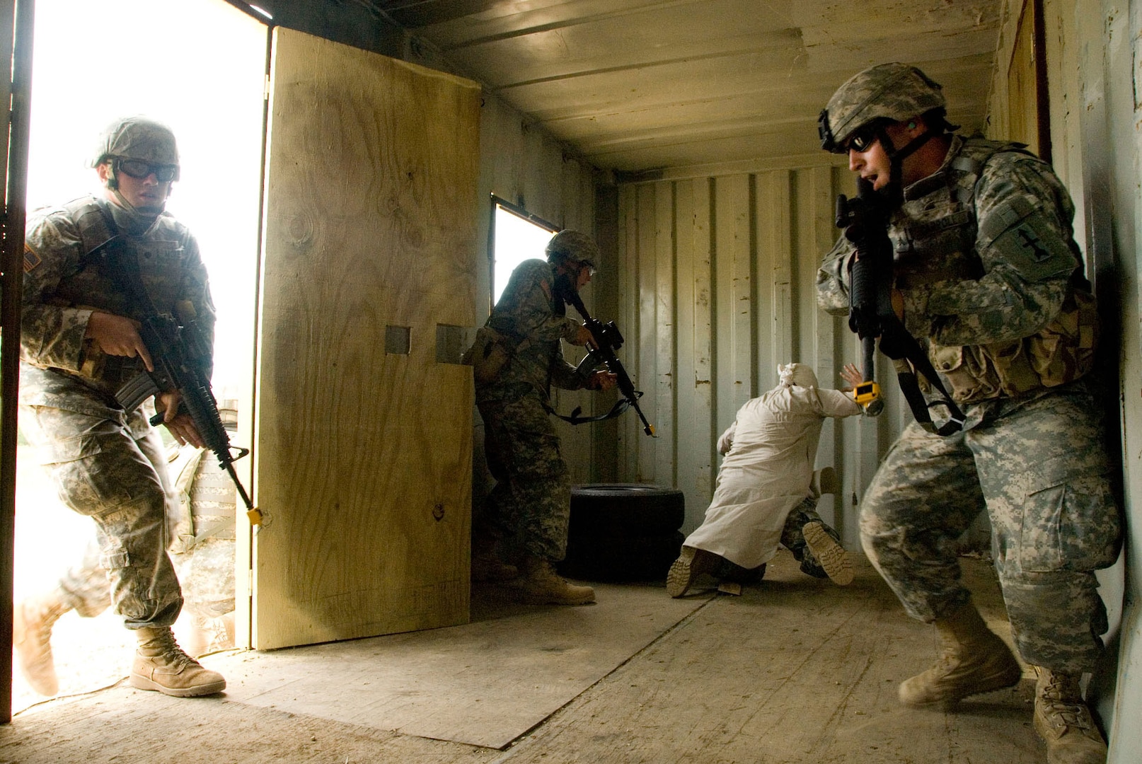 A mock Iraqi villager, portrayed by Staff Sgt. Brian Varn, Wisconsin Rapids, is surprised and captured by members of the 132nd Brigade Support Battalion, Wisconsin Army National Guard, as they practice urban combat at one of Fort McCoy's military urban training sites Aug. 12, 2008. The unit is part of the 32nd Infantry Brigade Combat Team, performing a 3-week Annual Training at Fort McCoy in preparation for an expected deployment to Iraq in early 2009. The brigade's training receives logistical support from elements of the 157th Maneuver Enhancement Brigade.