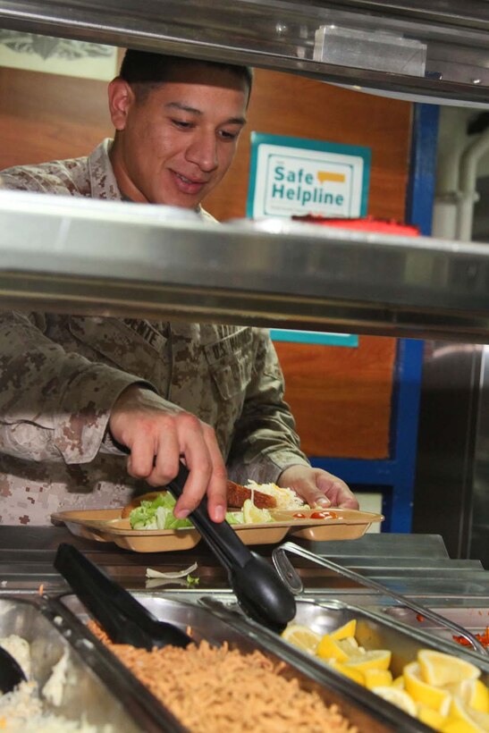 130425-M-VZ265-002 USS RUSHMORE (April 25, 2013) Sergeant Gabriel Delafuente, data networks specialist, Combat Logistics Battalion 15, 15th Marine Expeditionary Unit, makes a salad on the mess deck of the USS Rushmore, April 25. The 15th MEU is comprised of approximately 2,400 Marines and sailors and is deployed as part of the Peleliu Amphibious Ready Group. Together, they provide a forward-deployed, flexible sea-based Marine Air Ground Task Force capable of conducting a wide variety of operations ranging from humanitarian aid to combat. Delafuente, 24, is from Wesloco, Texas. (U.S. Marine Corps photo by Cpl. Timothy Childers/Released)