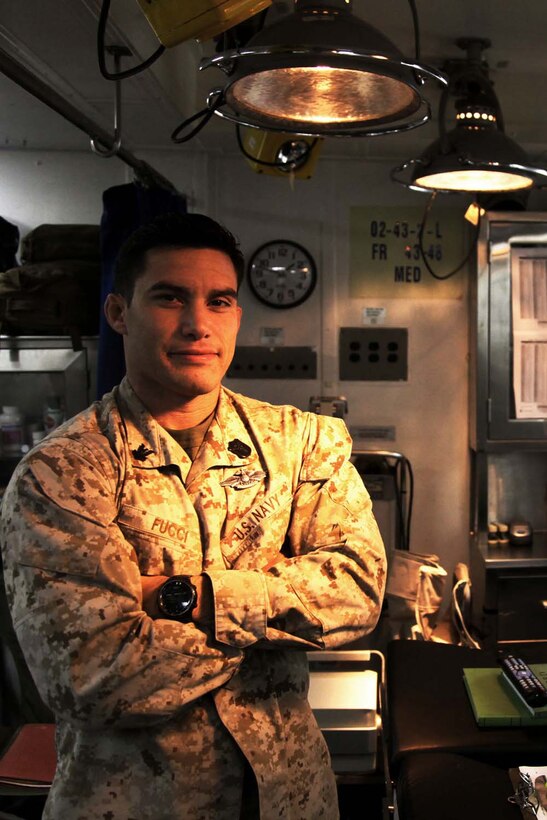 130424-M-VZ265-022 USS RUSHMORE (April 24, 2013) Petty Officer 2nd Class Marcel O. Fucci, corpsman, Health Services Detachment, Combat Logistics Battalion 15, 15th Marine Expeditionary Unit, poses for a photo in the medical department of USS Rushmore, April 24. Fucci, a 29-year-old native of Orlando, joined the Navy a week before the events on Sept. 11, 2001. Working as a Corpsman for more than 11 years, he has learned what it means to help others. The 15th MEU is comprised of approximately 2,400 Marines and sailors and is deployed as part of the Peleliu Amphibious Ready Group. Together, they provide a forward-deployed, flexible sea-based Marine Air Ground Task Force capable of conducting a wide variety of operations ranging from humanitarian aid to combat. (U.S. Marine Corps photo by Cpl. Timothy Childers/Released)