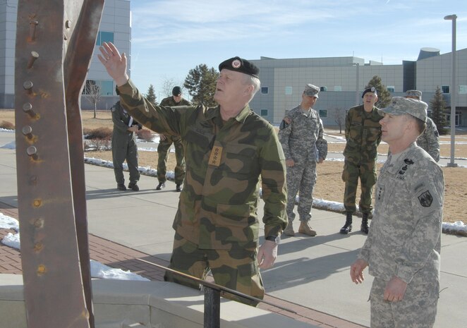 PETERSON AIR FORCE BASE, Colo. - General Harald Sunde, Norwegian Chief of Defense Staff, reaches out to touch the World Trade Center girder that makes up part of the NORAD and USNORTHCOM 9/11 Memorial upon his arrival at the commands' headquarters Feb. 13. Sunde, the Norwegian equivalent of the U.S. Chairman of the Joint Chiefs of Staff, is visiting to conduct talks to NORAD and USNORTHCOM leadership. During his visit, he received tours of the NORAD and USNORTHCOM Command Center and the Cheyenne Mountain complex. (U.S. Air Force photo by Tech. Sgt. Thomas J. Doscher)