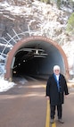 CHEYENNE MOUNTAIN AIR FORCE STATION, Colo. - Kay Partridge, daughter of Air Force Gen. Earle E. Partridge, poses for a photo outside the entrance of Cheyenne Mountain Air Force Station, Colo., Feb. 15. Partridge's father was the commander of the North American Air Defense Command at Ent AFB, Colo., in 1955 and was the driving force behind the construction of CMAFS. Kay Partridge was given a tour of the facility her father worked so hard to complete and command. General Partridge retired from the Air Force in 1959 and passed away in 1990. (U.S. Air Force photo by Marisa Novobilski)                             