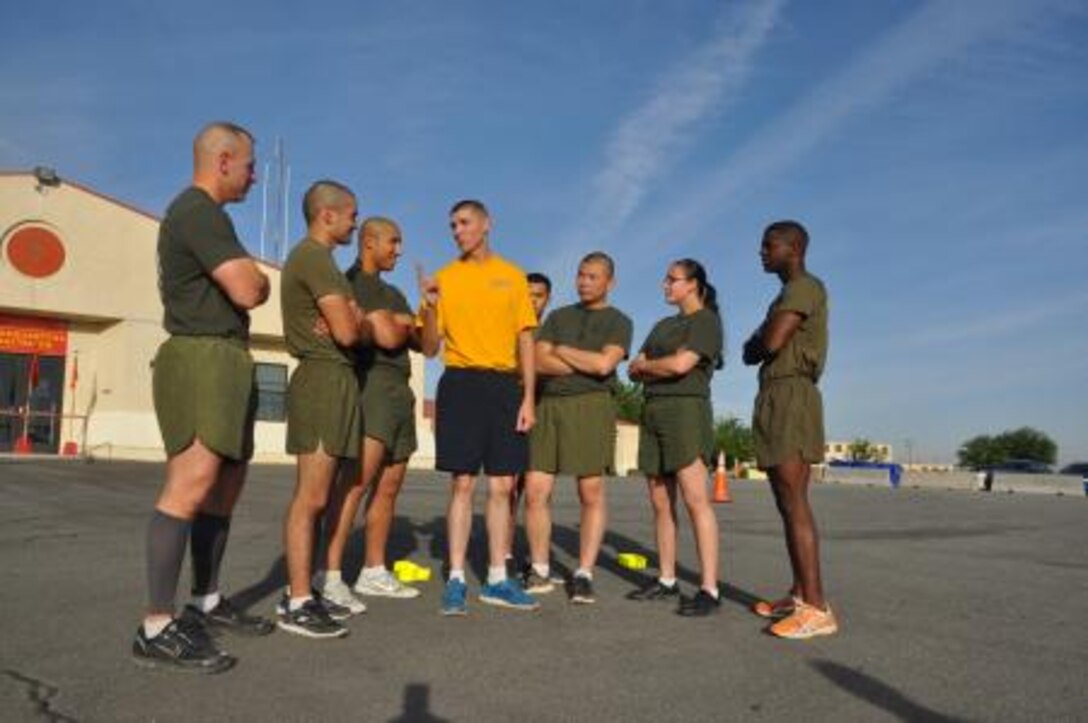 Petty Officer 3rd Class Barry Menges, the religious program specialist on Marine Corps Logistics Base Barstow stands surrounded by Marines as he talks to them after a physical training session, April 24. Menges, the only enlisted sailor on base, has become a part of the Marine family over the past few months.
