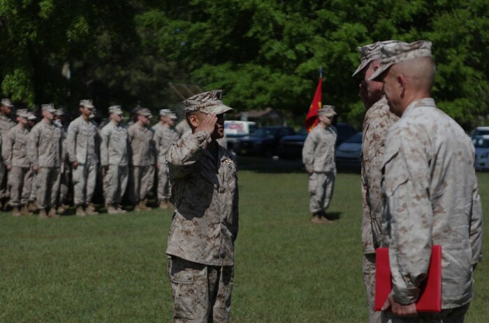 Navy Lt. Wilfredo L. Lucas, the operations officer for 2nd Medical Battalion, Combat Logistics Regiment 25, 2nd Marine Logistics Group, salutes Brig. Gen. Edward D. Banta, the commanding general of 2nd MLG during a Bronze Star Medal ceremony aboard Camp Lejeune, N.C., April 24, 2013. Lucas introduced changes to the Afghan National Army, or ANA’s, healthcare system, which increased the efficiency and knowledge of the ANA doctors.