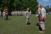 Navy Lt. Wilfredo L. Lucas (center), 2nd Medical Battalion, Combat Logistics Regiment 25, 2nd Marine Logistics Group’s operations officer, stands in front of the battalion before receiving the Bronze Star Medal during an award ceremony held by the unit aboard Camp Lejeune, N.C., April 24, 2013. Brig. Gen. Edward D. Banta, the commanding general of 2nd MLG, personally awarded Lucas with the medal.