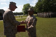 Navy Lt. Wilfredo L. Lucas (right), the operations officer of 2nd Medical Battalion, Combat Logistics Regiment 25, 2nd Marine Logistics Group, shakes hands with Brig. Gen. Edward D. Banta, the commanding general of 2nd MLG, during a Bronze Star ceremony aboard Camp Lejeune, N.C., April 24, 2013. Banta personally awarded the medal to Lucas and expressed his thanks for Lucas’ lifesaving actions in Afghanistan.
