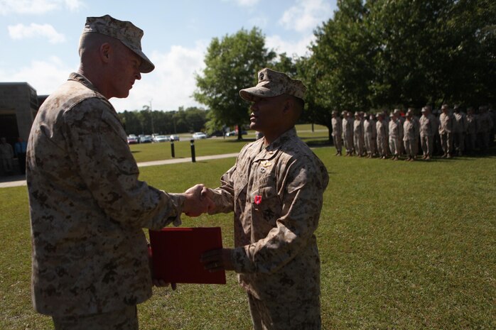Navy Lt. Wilfredo L. Lucas (right), the operations officer of 2nd Medical Battalion, Combat Logistics Regiment 25, 2nd Marine Logistics Group, shakes hands with Brig. Gen. Edward D. Banta, the commanding general of 2nd MLG, during a Bronze Star ceremony aboard Camp Lejeune, N.C., April 24, 2013. Banta personally awarded the medal to Lucas and expressed his thanks for Lucas’ lifesaving actions in Afghanistan.