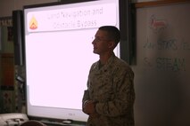 Sgt. Joshua A. Oakes, a tactics readiness and training, or TRT, instructor with Combat Logistics Regiment 27, 2nd Marine Logistics Group, teaches students about navigating around obstacles and terrain features at Brewster Middle School aboard Camp Lejeune, N.C., April 25, 2013. Marines with TRT taught the seventh grade class the basics of land navigation and performed practical application tasks about what they learned. 