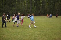 Seventh-grade students perform a pace count with Marines of Combat Logistics Regiment 27, 2nd Marine Logistics Group at Brewster Middle School during a land navigation class taught by the Marines aboard Camp Lejeune, N.C., April 25, 2013. The students applied techniques they learned in class to find empty ammunition containers at long distances. 