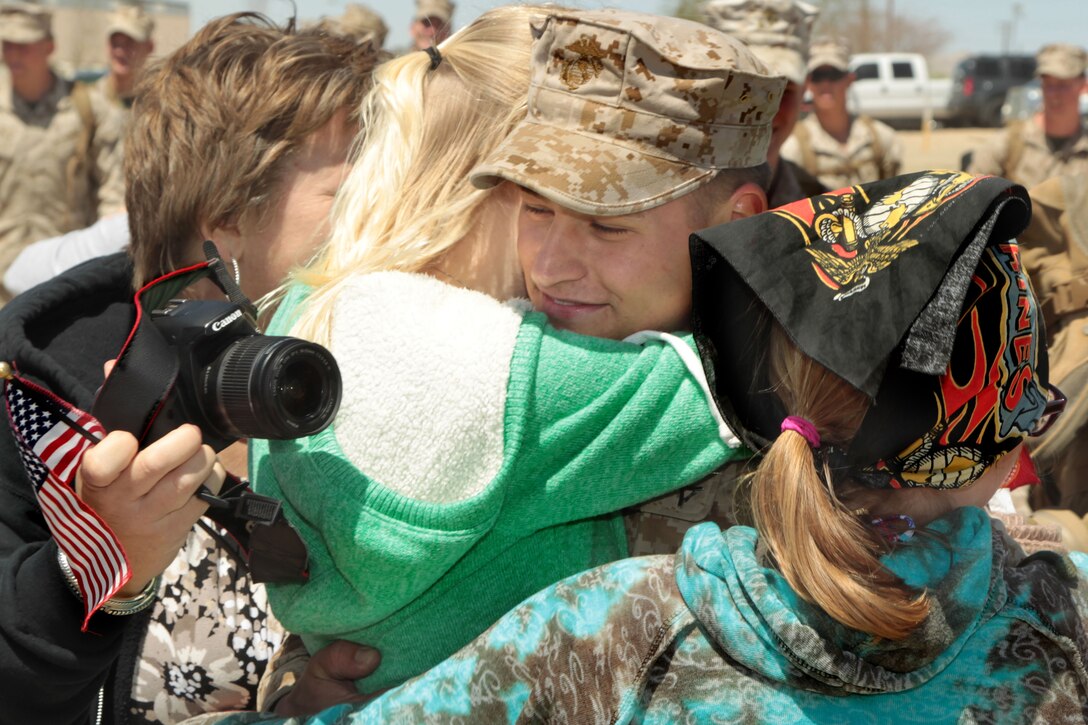 Lance Cpl. Travis Titchenell, mortarman, 2nd Battalion, 7th Marine Regiment, is welcomed home by his family during the battalion's homecoming ceremony at Del Valle Field April 9, 2013. 