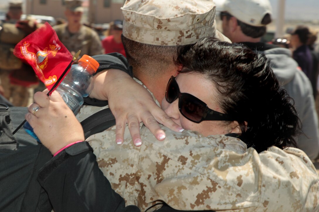 Lance Cpl. Jacob Owen, mortarman, Weapons Company, 2nd Battalion, 7th Marine Regiment, is welcomed home by his mother, Tracey Owen, during the battalion's homecoming ceremony at Del Valle Field April 9, 2013. 