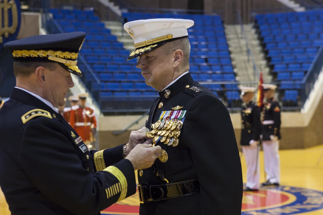 Gen. Martin E. Dempsey, chairman of the Joint Chiefs of Staff, right, pins a Defense Distinguished Service Medal on Gen. John R. Allen during a retirement ceremony at the Naval Academy, Annapolis, Md., April 29. Allen retired after more than 30 years of faithful service to the Marine Corps.