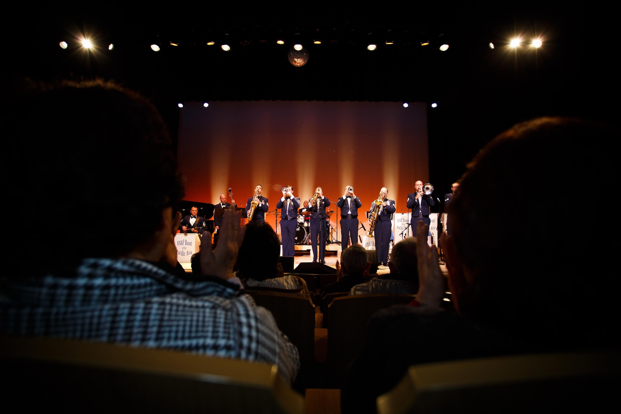 The audience cheers as the U.S. Air Force Band of the Pacific-Asia performs April 20, 2013, at Ishinomaki City, Japan. Much of the town is still in disrepair from the earthquake and tsunami that ravaged the area approximately two years ago. The band completed a 3-day tour of various cities in Japan April 20 through 22, to remember the victims of the earthquake and tsunami that ravaged the area approximately two years ago. (U.S. Air Force photo/Staff Sergeant Josh Voyles)