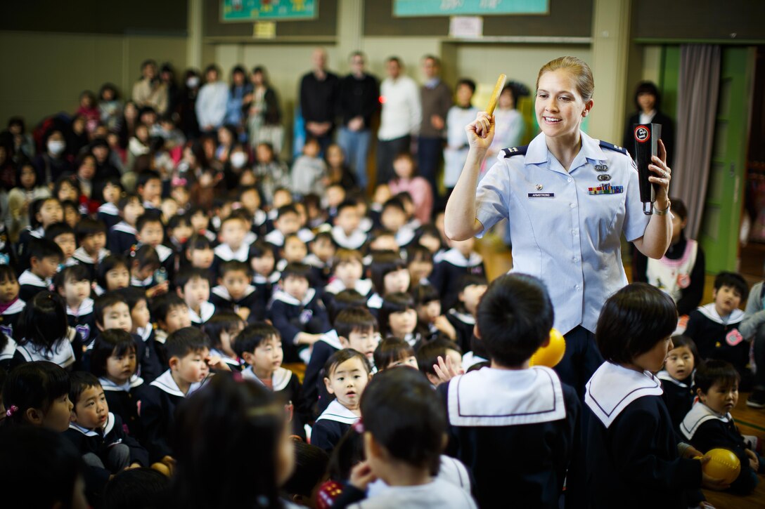 Capt. Haley Armstrong, the U.S. Air Force Band of the Pacific commander, performs for Japanese kindergarten students during a concert by the U.S. Air Force Band of the Pacific-Asia at Shichigo, Japan April 22, 2013. Many of these students and their families were displaced from the earthquake and tsunami of 2011. (U.S. Air Force photo/Staff Sergeant Josh Voyles)