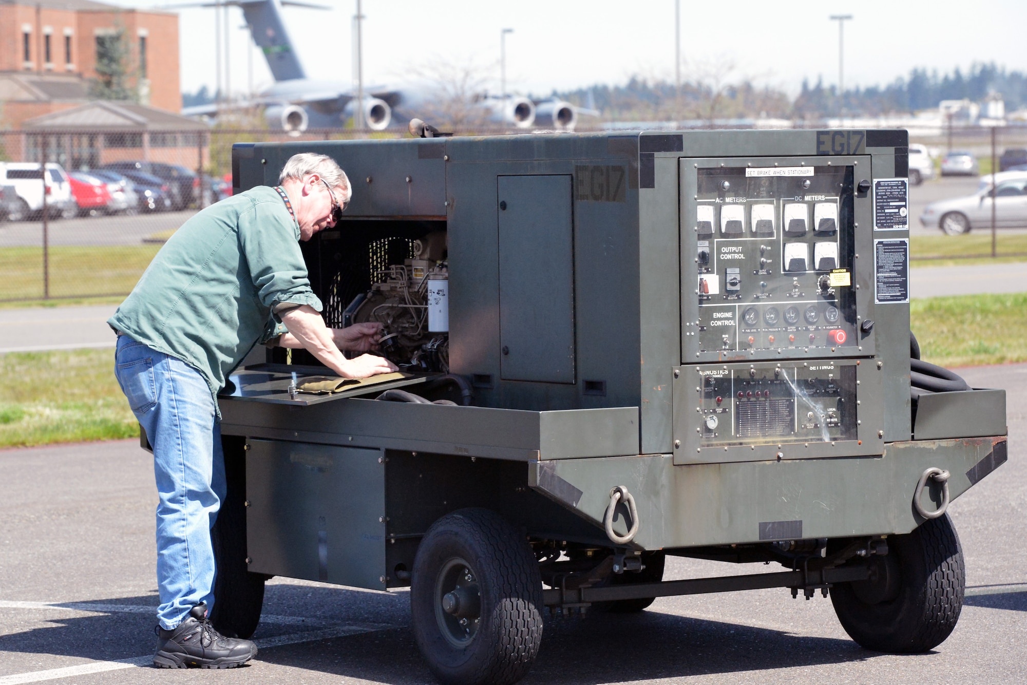 Robert Weaver, 62nd Maintenance Squadron Aerospace Ground Equipment power systems support technician, checks the oil on a -86 diesel generator during a service inspection, April 25, 2013 at Joint Base Lewis-McChord, Wash. Weaver began his Air Force career at McChord in 1976 and is a retired senior master sergeant with more than 32 years of service. (U.S. Air Force photo/Airman 1st Class Jacob Jimenez)