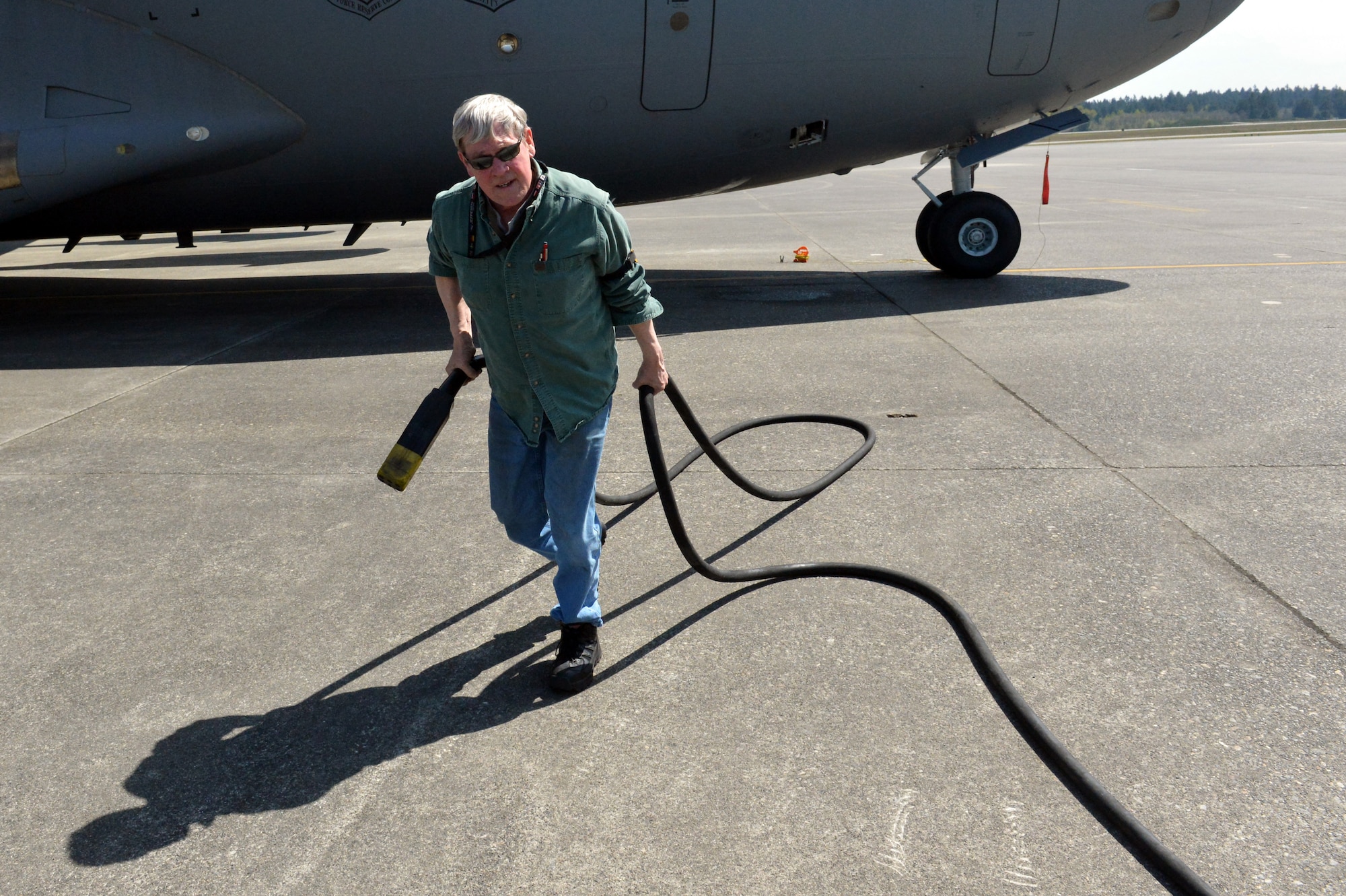 Robert Weaver, 62nd Maintenance Squadron Aerospace Ground Equipment power systems support technician rolls up a -86 diesel generator’s power cable prior to switching the unit out, April 25, 2013 at Joint Base Lewis-McChord, Wash. AGE generators provide electrical power to parked aircraft so the aircraft doesn’t have to use its own power. (U.S. Air Force photo/Airman 1st Class Jacob Jimenez)